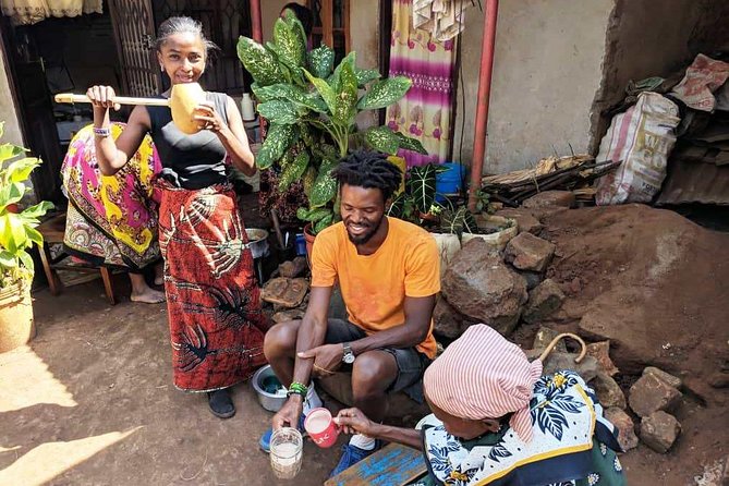 Private Market Tour and Tanzanian Cooking Class in Moshi - The family meal outdoors: peanut brittle and homemade alcohol